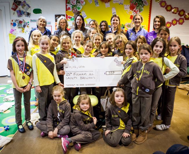 Fulham Brownies with cheque for Great Ormond Street Hospital