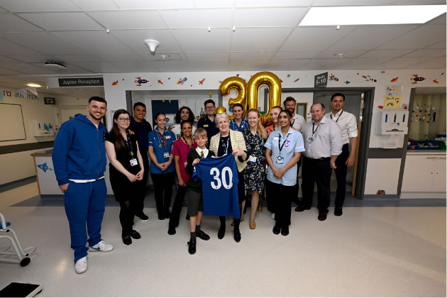 CEO of Chelsea and Westminster Hospital Lesley Watts, with staff and patient alongside the 30 shirt that was gifted by Chelsea FC