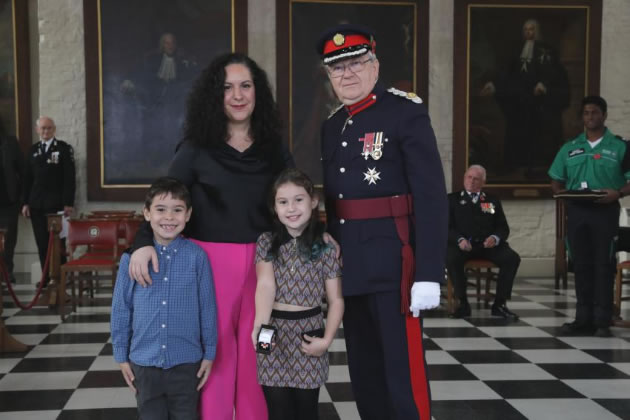 Chris Streat's widow Maria and the couple’s two children, Rosalita and Santino, accepting the Order of St John on his behalf