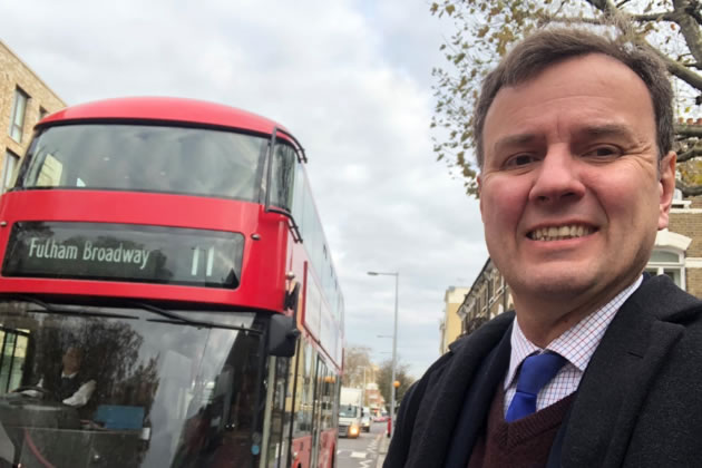Greg in front of the Number 11 bus, one of the buses he is campaigning to save