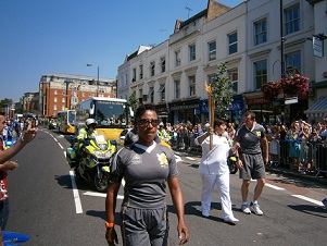 Georgie Mosley carries the Olympic torch in Fulham
