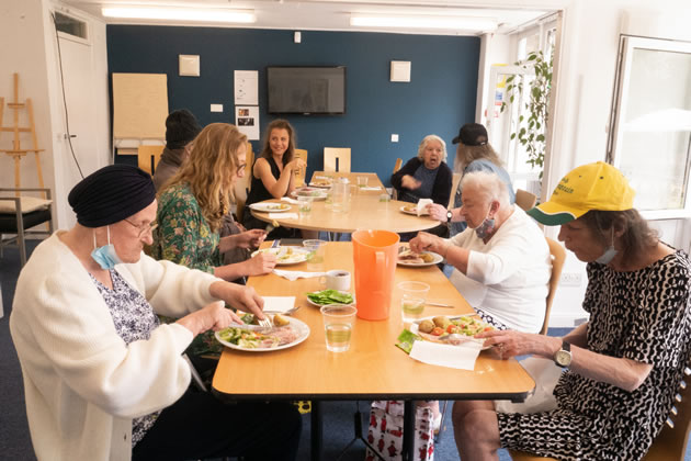 Lillian Urban (left) tucks into her lunch at AgeUK's centre in Greyhound Road. Picture: AgeUK