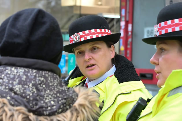 Members of the council's law enforcement team talking to a member of the public