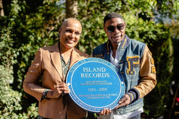Dr Jak Beula (right), CEO of the Nubian Jak Community Trust, holding the blue plaque